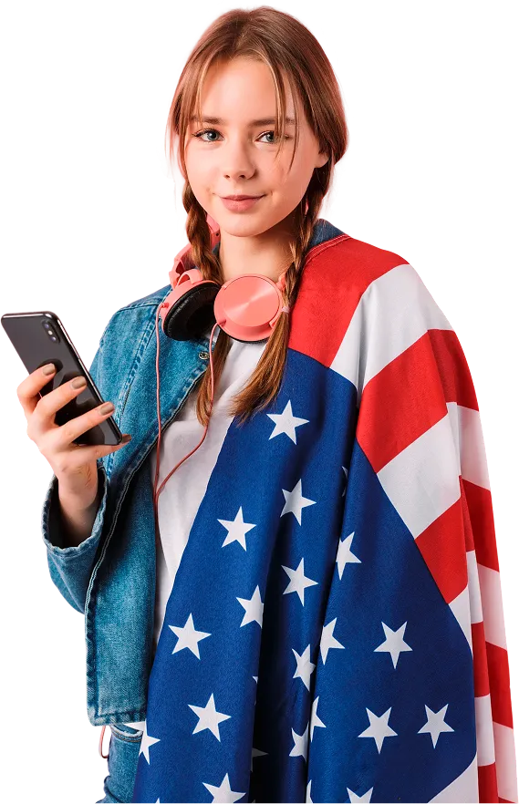 usa-young-beautiful-girl-with-two-braids-denim-jacket-with-headphones-big-american-flag-shoulder-holding-cellphone-hand-while-happily-looking-camera-pink-background.webp